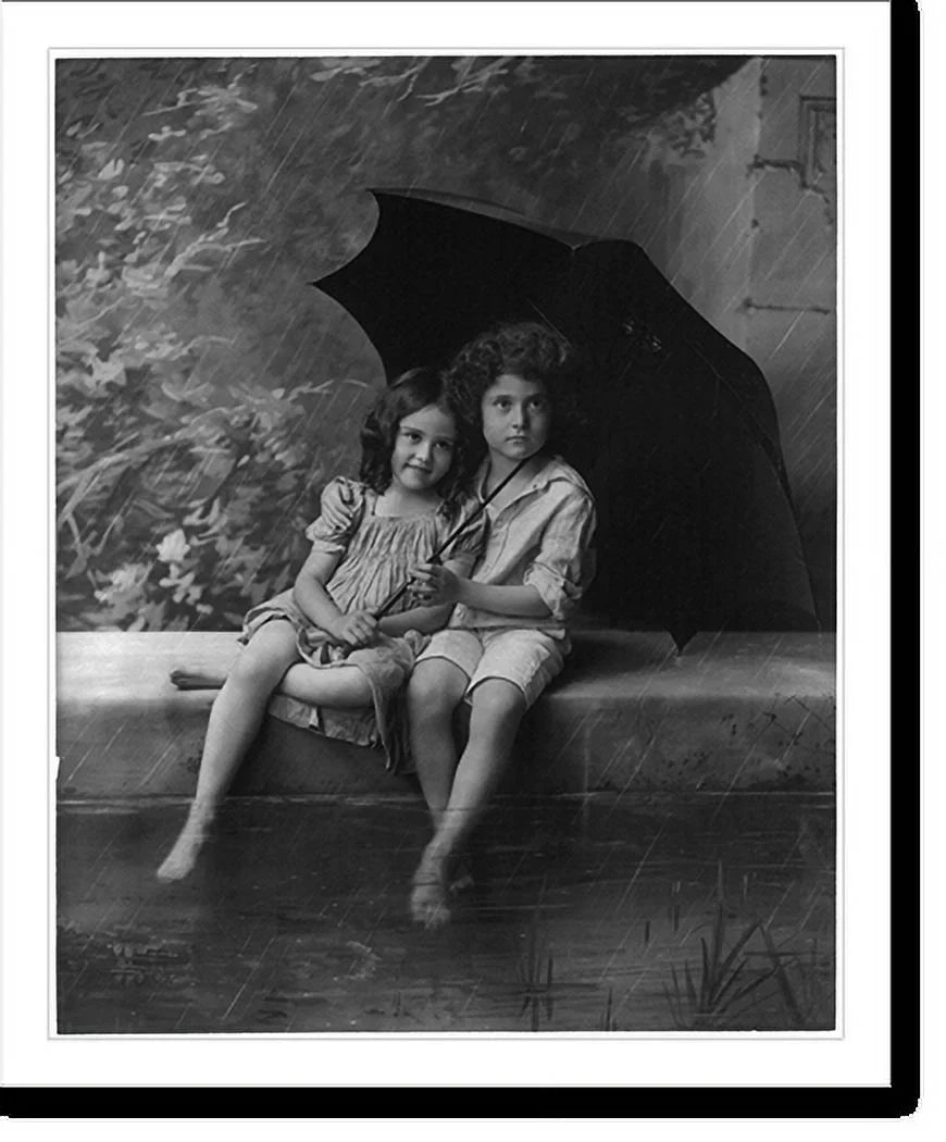 Historic Framed Print, [2 children on fountain wall, under umbrella in rain], 17-7/8" x 21-7/8"